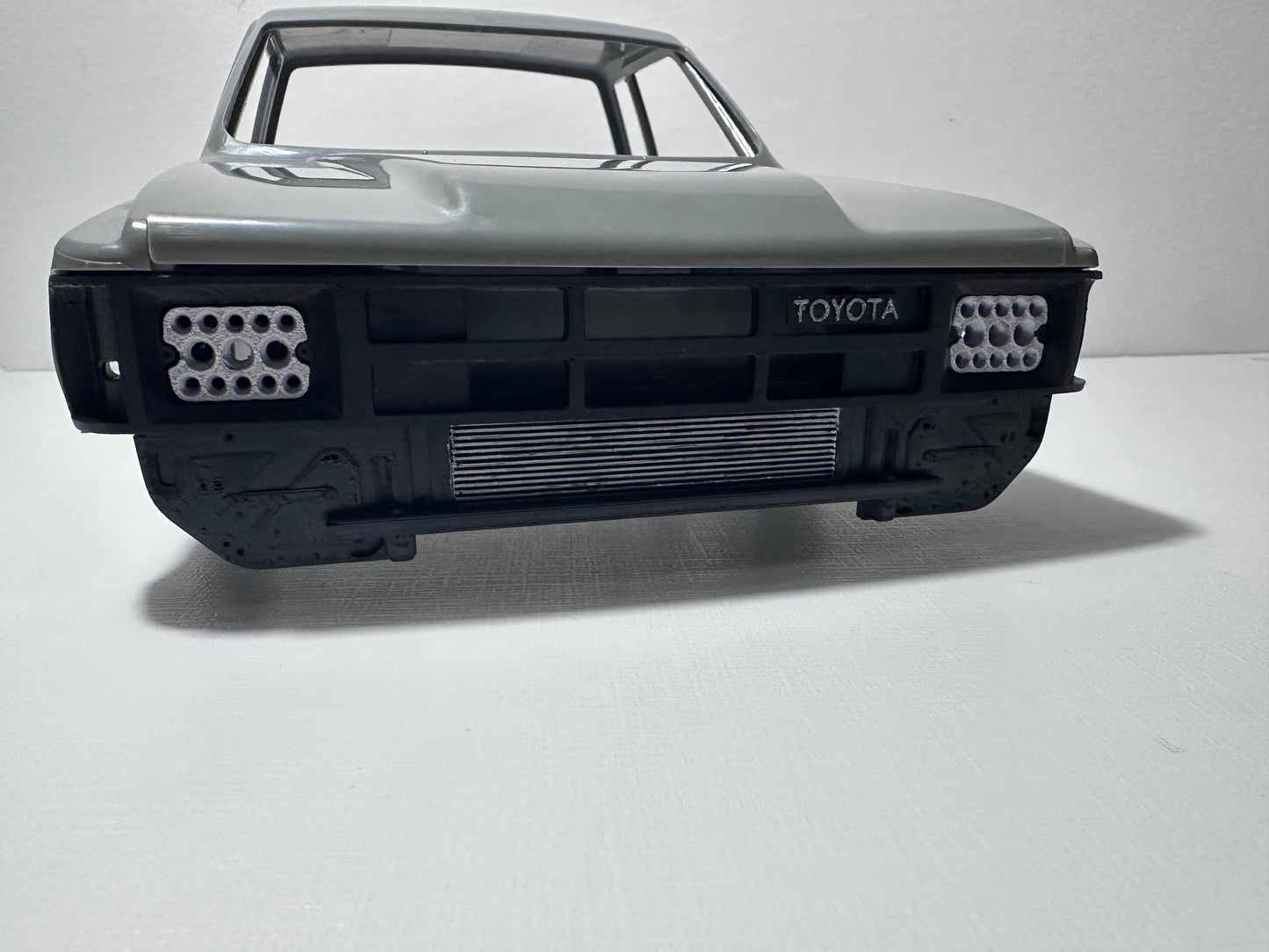 RockSlugCustoms ‘85 Hilux/XtraCab Grill w/ Light Bucket Inserts (physical product)