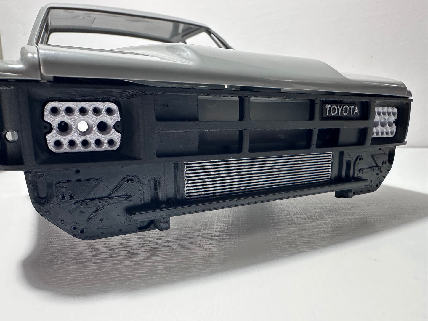 RockSlugCustoms ‘85 Hilux/XtraCab Grill w/ Light Bucket Inserts (physical product)